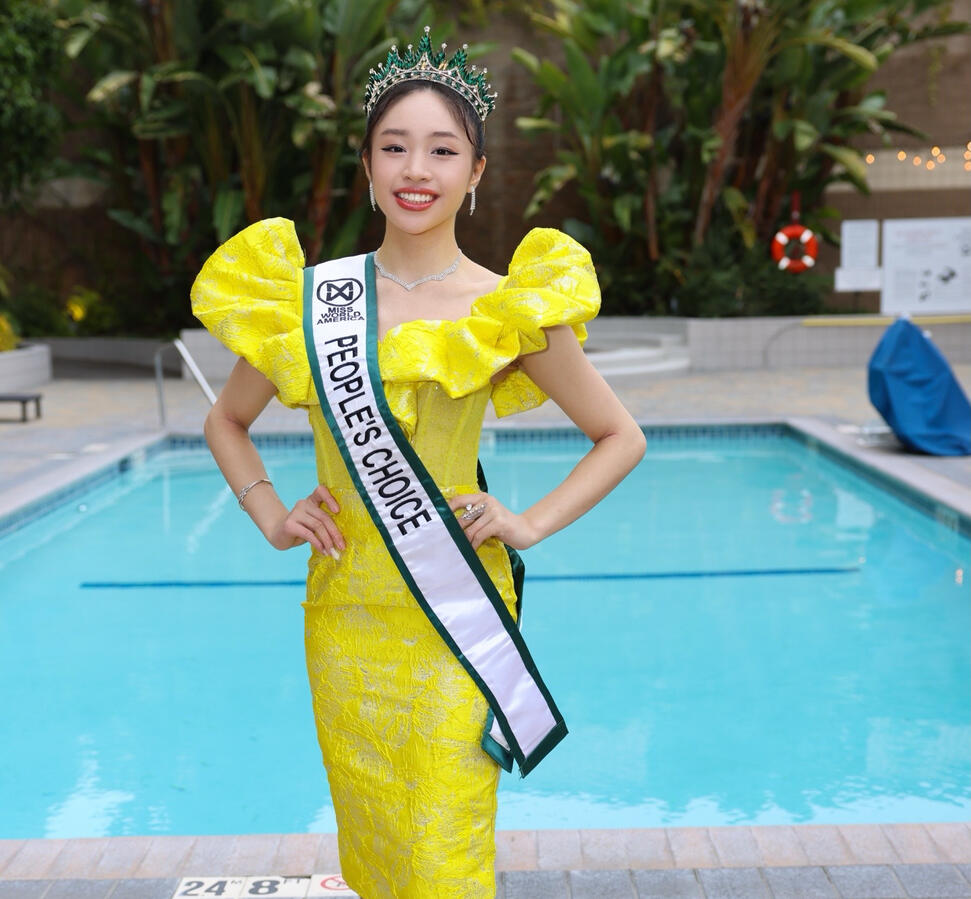 Full body poolside photo of Angeli Chaves in yellow Filipiniana dress and crown for FAPCCA event in Los Angeles